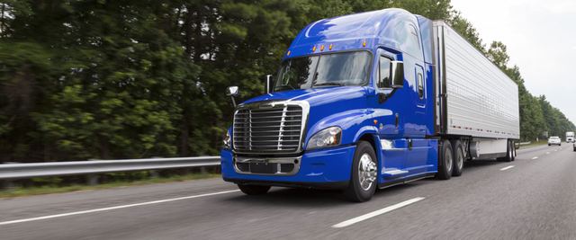 Blue semi-truck with trailer on a highway